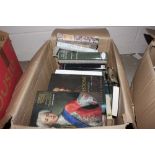 A box containing mostly Book Club books