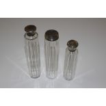 Three glass and silver mounted tidy jars