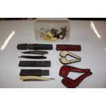 A plastic tub and contents of razors, pipe cases e