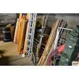 A quantity of long handled tools and bow saws etc.