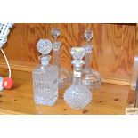 A pair of cut glass decanters and stoppers and two