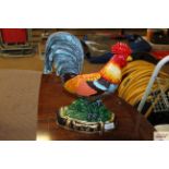 A door stop in the form of a decorative cockerel (