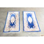 A pair of 4'2" blue floral pattern rugs