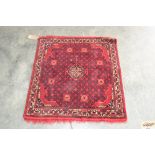 An approximate 3'1" x 2'8" red pattern rug