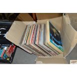 A box containing various LPs