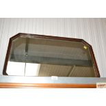 An oak framed and bevelled edge wall mirror