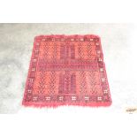 An approximate 3'1" x 2'8" red pattern rug