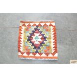 An approximate 1'5" x 1'5" Chobi Kelim rug