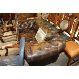 A leather chesterfield two seater sofa with variou