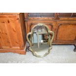 A shaped wall mirror contained in gilt frame
