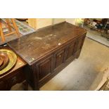 An antique oak panelled coffer fitted single drawe