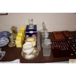 A pair of etched glass decanters, three other deca