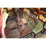 A set of four spindle back dining chairs, elm seat