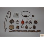 A collection of various silver lockets and other s