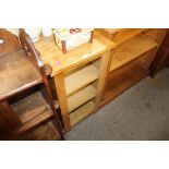 An oak open fronted bookcase of small proportions,