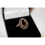 A boxed silver; marcasite and garnet set ring