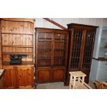 A walnut bookcase with astragal glazed doors, rais