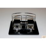 An art deco black glass and metal desk stand