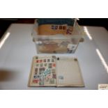 A box of various loose stamps and stamp album
