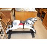 A large rocking horse with glass eyes