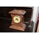 An oak cased two hole mantle clock