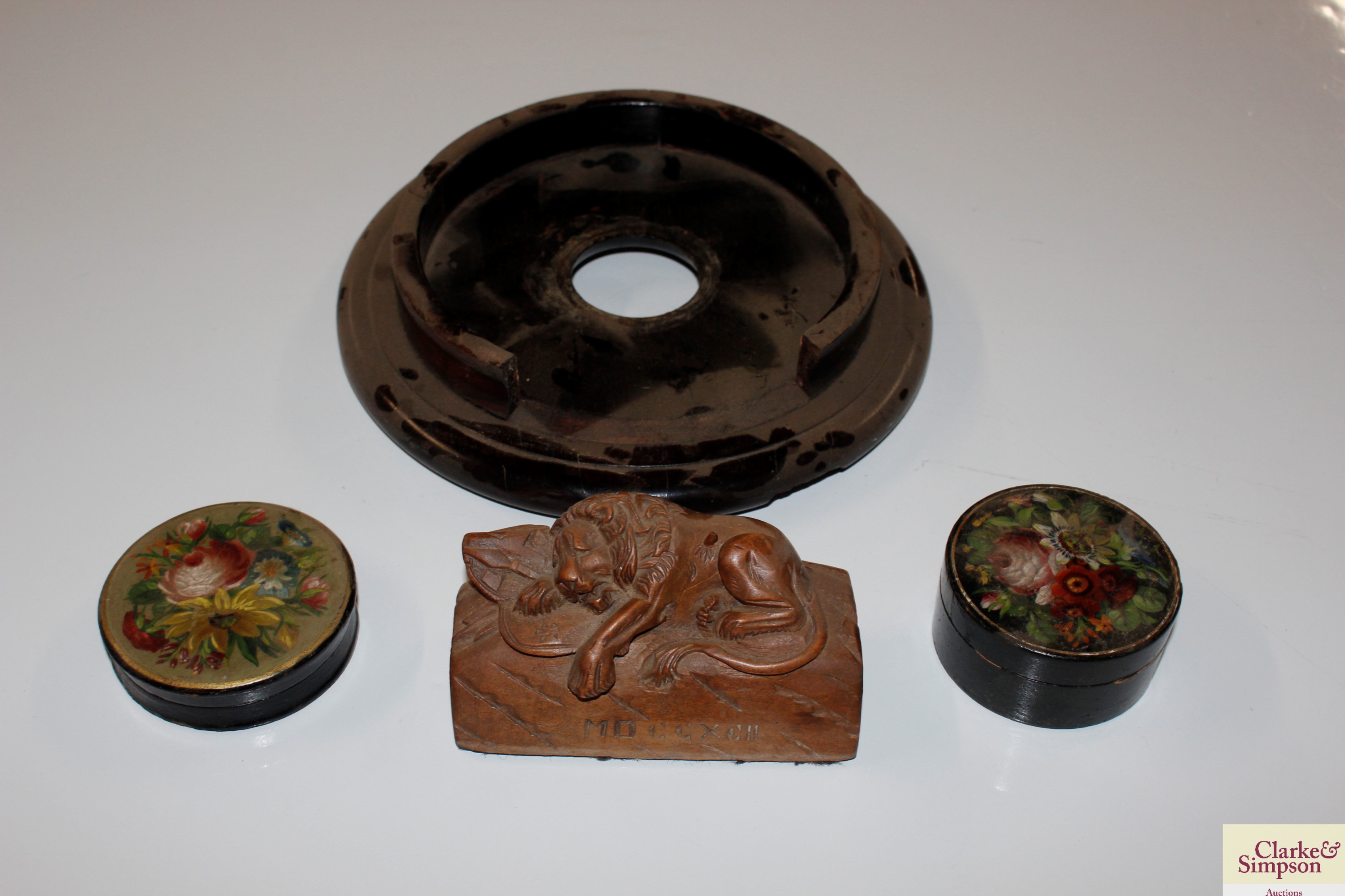 Two floral painted boxes and a carved wooden lion