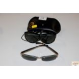 Two pairs of Ray Ban sunglasses, one with case