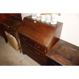 A mahogany bureau fitted three graduating drawers