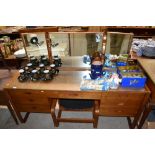 A Uniflex teak dressing table fitted seven drawers