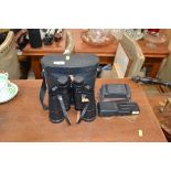 A pair of Pentax binoculars and two vintage camera