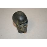 A walking stick handle in the form of a skull (149