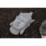 A garden plaque in the form of a Buddhas head