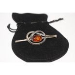 A vintage silver and amber brooch