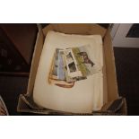 A box containing various horse prints and postcard