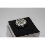 A white metal and diamonte cluster ring