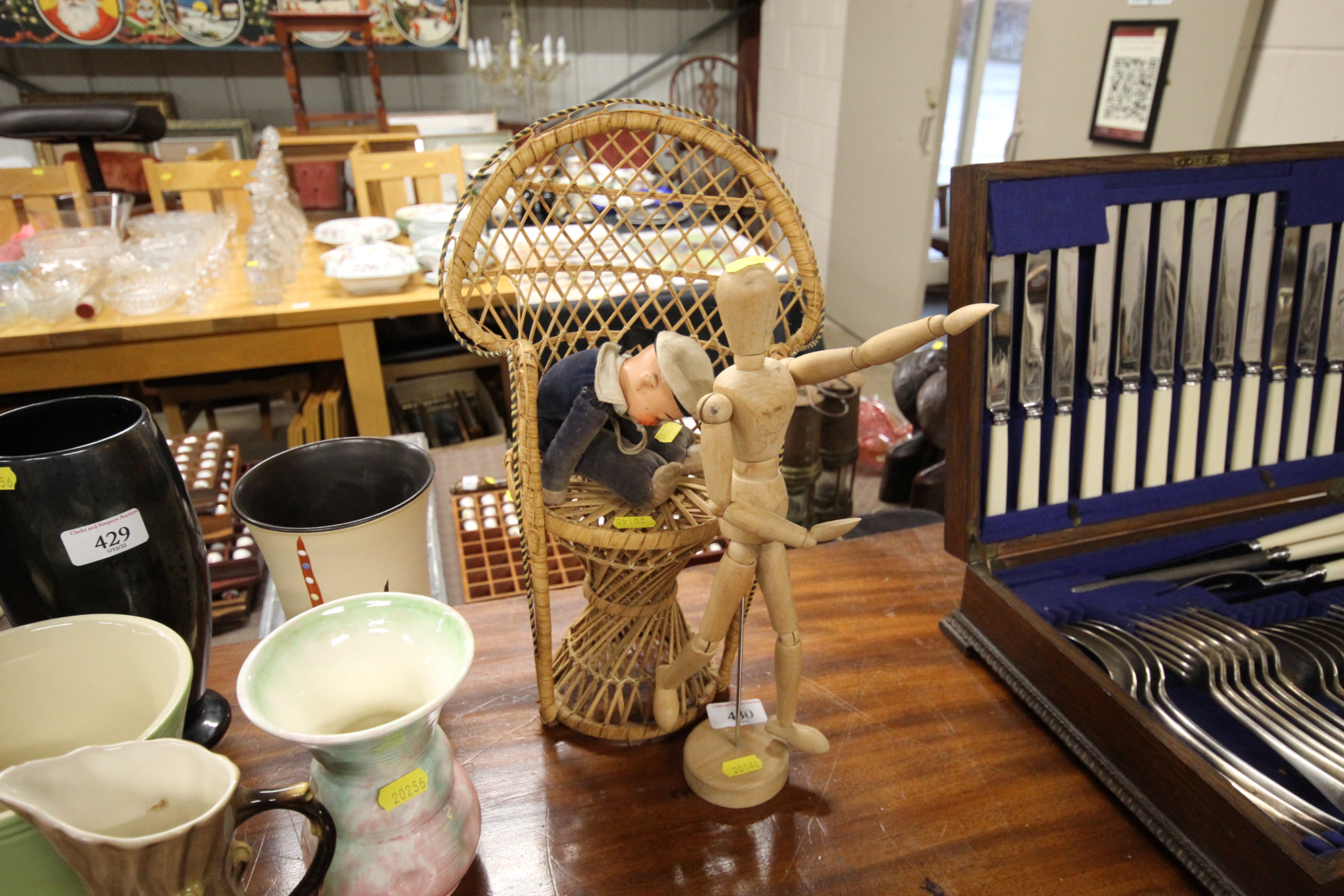 A ley doll, a wicker doll's chair and a sailor dol