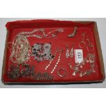 A tray of various white metal and diamante set jewellery, to include chains