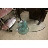 A modern oval glass coffee table