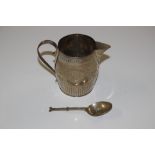 A George III silver cream jug and a plated spoon