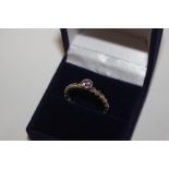 A 925 and amethyst coloured dress ring