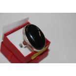 A very large sterling silver and black onyx ring,