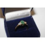 A 925 emerald and white stone ring