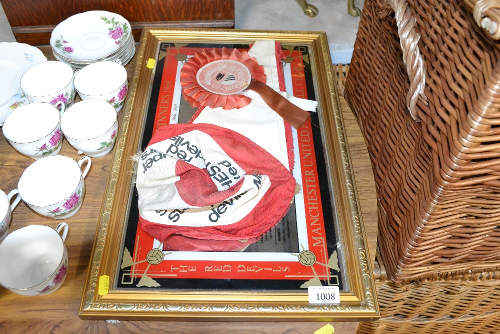 A Manchester United advertising mirror, hat and pe