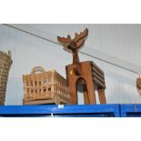 A wooden planter in the form of a reindeer and a w