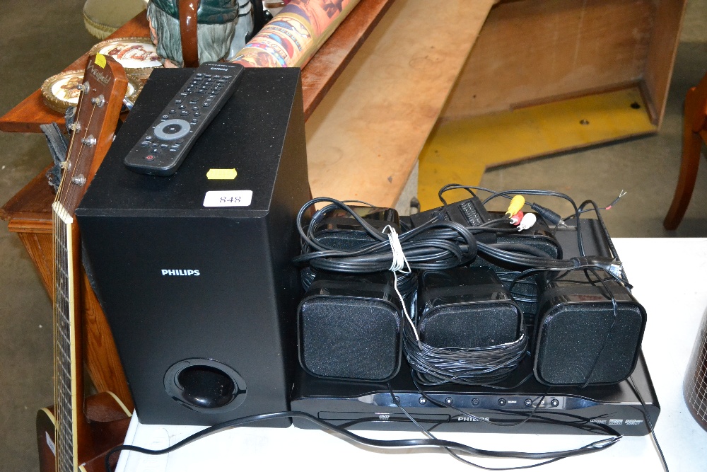 A Philips DVD player and surround sound speakers