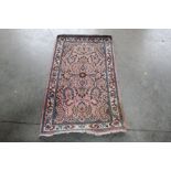 An approx. 4'3" x 2'3" pink and blue pattern rug