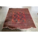 An approx. 6' x 4'10" red pattern rug