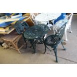 A small ornate green-painted metal bistro set