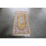 An approx. 4'7" x 2'1" yellow floral pattern rug