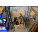 A large wicker fan and box containing various pict